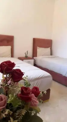 a bedroom with two beds with roses on the floor at New nice apartment city center swimming pool wifi in Marrakech