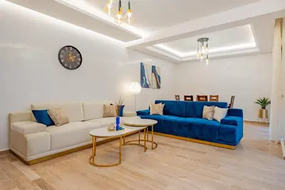 a living room with a blue couch and a table at Luxueux appartement -70 haut gamme Guéliz in Marrakech