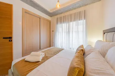 a bedroom with a large white bed with a window at Luxueux appartement -70 haut gamme Guéliz in Marrakech