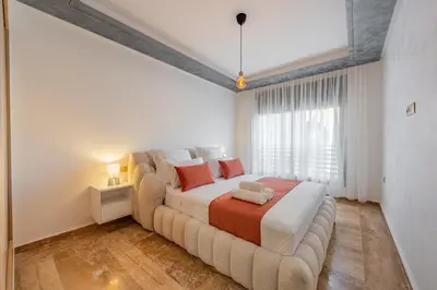 a bedroom with a large bed and a large window at Apprtement -74-de luxe haut gamme guéliz in Marrakech