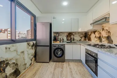 a kitchen with a washer and a dishwasher at Apprtement -74-de luxe haut gamme guéliz in Marrakech