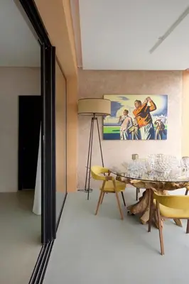 a dining room with a table and chairs and a painting at Villa zen in Marrakech