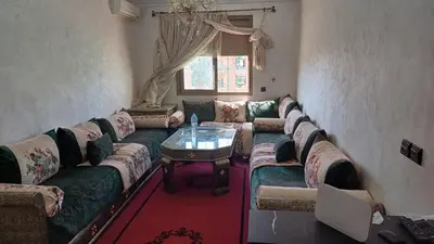 a living room with a couch and a table at الأزهار in Marrakech