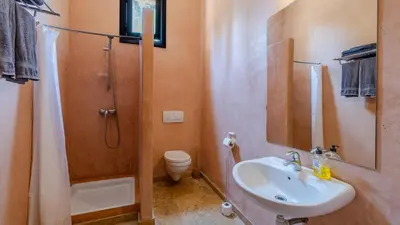 a bathroom with a sink and a shower and a toilet at la villa du golf in Sfiani