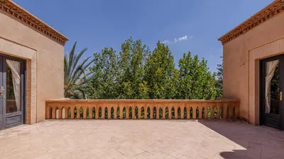 an empty courtyard of a house with a wooden fence at la villa du golf in Sfiani