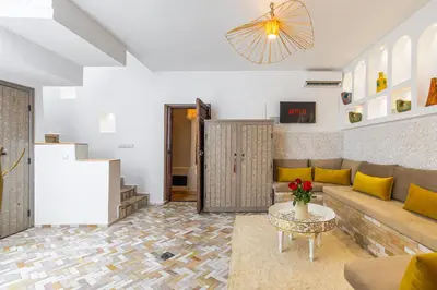 a living room with a couch and a table at Riad Symba Exclusive with New Heated Pool and Breakfast Included in Marrakech