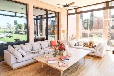 a living room with a couch and a table at Villa Angel 42 Al Maaden Golf Resort in Marrakech