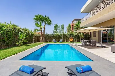 a swimming pool in the backyard of a house at Villa Narjisse , Élégance et Calme, piscine privée in Marrakech