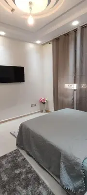 a bedroom with a bed and a flat screen tv at مراكش تاركة in Marrakech