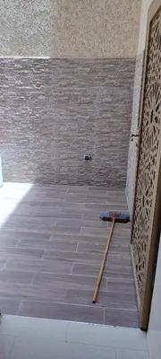 a room with a tile floor with a wooden stick at مراكش تاركة in Marrakech