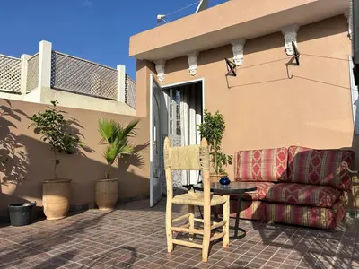 a couch sitting on a patio with a table at Riad Ramadan House Marrakech in Marrakech