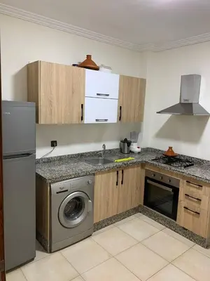 a kitchen with a sink and a washing machine at Nour5 in Marrakech