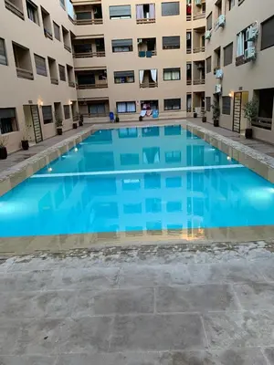 a large swimming pool in front of a building at Nour5 in Marrakech