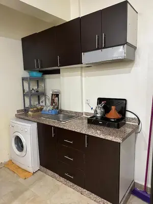 a kitchen with a sink and a washing machine at appartement 9 simple et fonctionnel pour famille in Marrakech