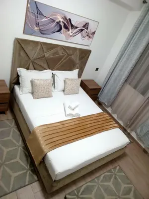 a bedroom with a bed with white sheets and pillows at Luxury Apartment With Swiming Pool in Hivernage Marrakech in Marrakech