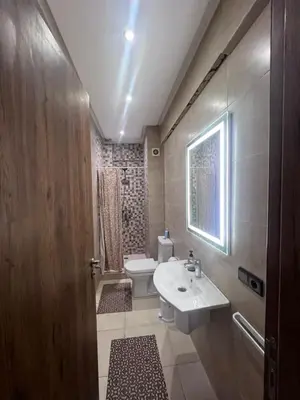 a bathroom with a sink and a toilet and a window at Luxury Apartment With Swiming Pool in Hivernage Marrakech in Marrakech