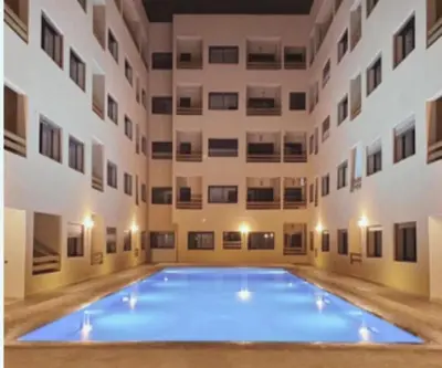a large swimming pool in the middle of a building at Luxury Apartment With Swiming Pool in Hivernage Marrakech in Marrakech