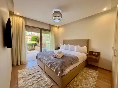 a bedroom with a bed with a stuffed animal on it at Prestigia Apart 29 in Marrakech