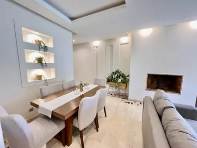 a dining room with a table and a couch at Prestigia Apart 29 in Marrakech