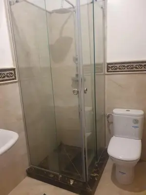 a bathroom with a shower with a toilet and a sink at Beautiful Central Marrakech Villa in Marrakech