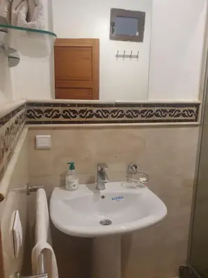 a bathroom with a white sink and a mirror at Beautiful Central Marrakech Villa in Marrakech