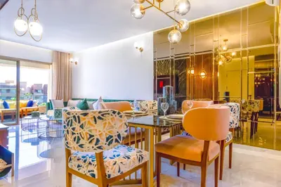 a dining room with a table and chairs at Appartement prestigia Jad in Marrakech