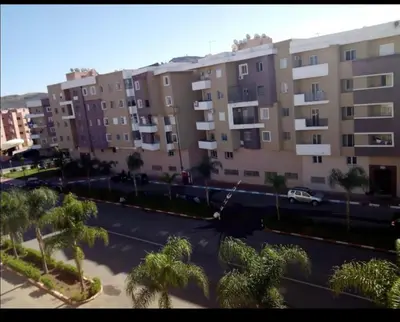 a view of a parking lot with palm trees and buildings at شقق جيليز in Marrakech