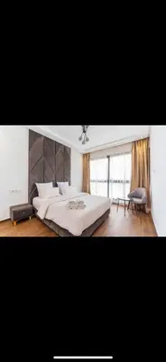 a bedroom with a large white bed and a chair at Beautiful villa Argan golf in El Makina