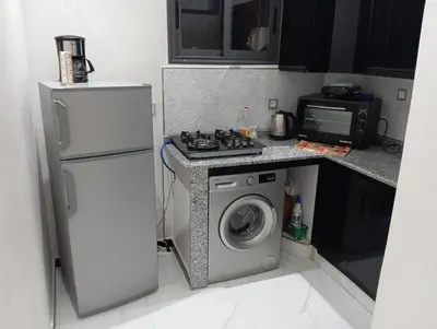a kitchen with a stove and a washing machine at Marrakech -giliz in Marrakech