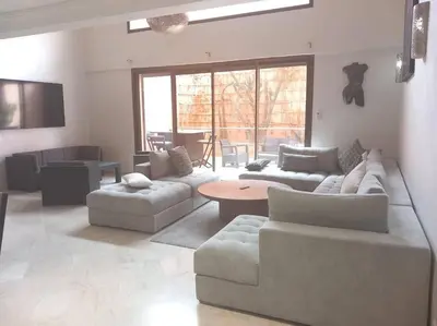 a large living room with couches and a table at Appartement Duplex Haut Standing in Marrakech