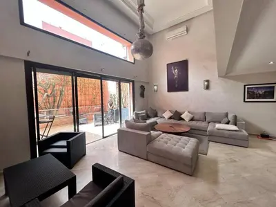 a large living room with a couch and a table at Appartement Duplex Haut Standing in Marrakech