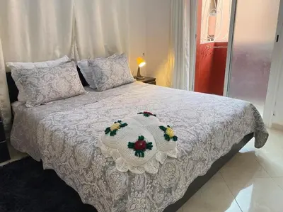 a bedroom with a white bed with a flower decoration on it at Appart élégance Gueliz in Marrakech