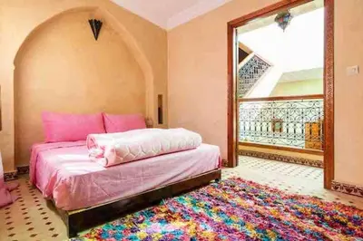 a bedroom with a bed and a large window at Al Qaria Assiyahia Riad Fadil 44 in Marrakech