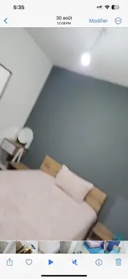 a picture of a room with a bed with pillows at Basatin targa a giliz in Douar Moulay Hafid
