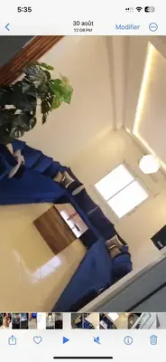 a room with two beds and a potted plant at Basatin targa a giliz in Douar Moulay Hafid