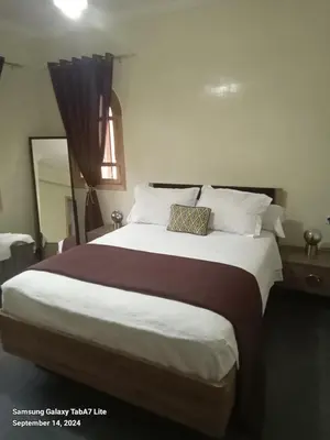 a bedroom with a large bed with a pillow on it at اقامة حمزة in Marrakech