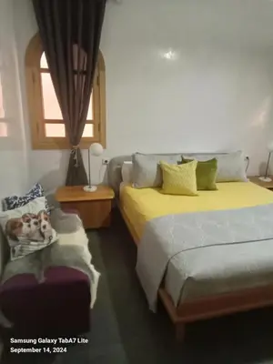 a bedroom with two beds and a window at اقامة حمزة in Marrakech