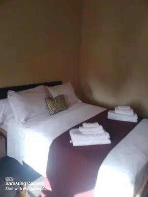 two beds in a room with towels on them at اقامة حمزة in Marrakech