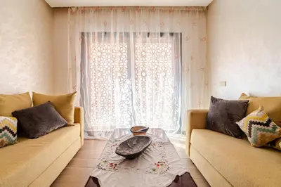 a living room with two couches and a window at Duplex romantique Esprit palais à Gueliz in Marrakech
