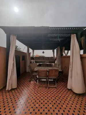 a dining room with a table and chairs under a tent at Atlas Golf resort in Sfiani