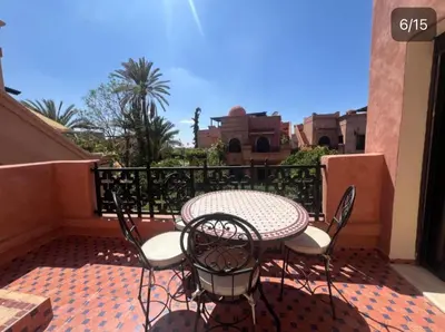 a patio with a table and chairs on a balcony at Atlas Golf resort in Sfiani