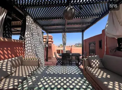 a pergola with a couch on a patio at Atlas Golf resort in Sfiani
