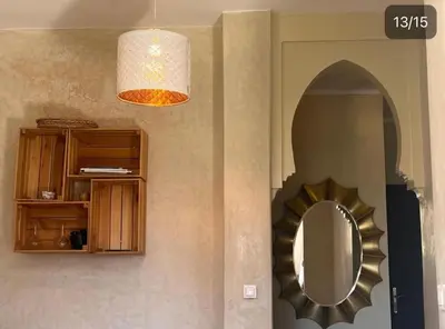 a bathroom with a mirror and a pendant light at Atlas Golf resort in Sfiani