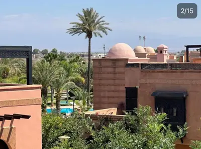 a view of a building with a palm tree and a pool at Atlas Golf resort in Sfiani