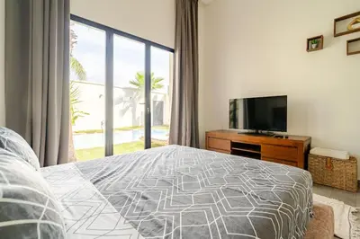a bedroom with a bed and a flat screen tv at Villa michlo in El Makina