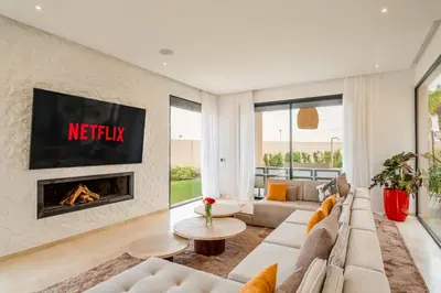 a living room with a couch and a fireplace at Villa Piscine, Salle de Sport et Confort Moderne in Marrakech
