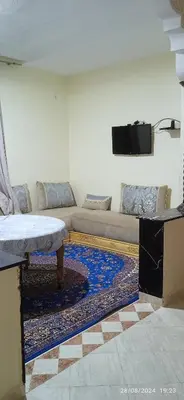 a living room with a couch and a flat screen tv at Nassim 298 in Marrakech