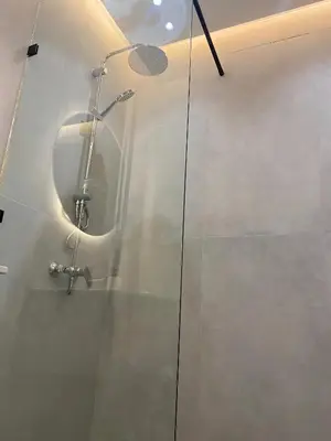 a shower in a bathroom with a glass door at Haut standing coeur Gueliz in Marrakech