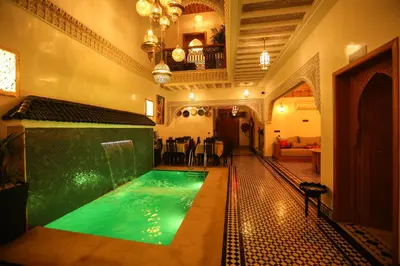 a pool in the middle of a house at Riad Palais MERYEM in Marrakech