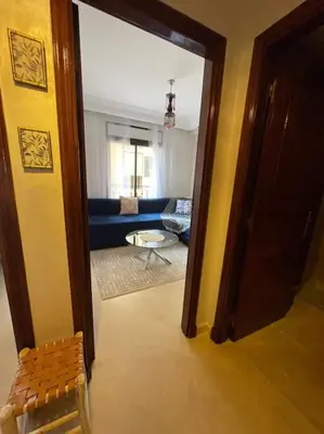 a hallway with a door open to a living room at Stylish & Comfy Gem 5 Star Location Balcony in Marrakech